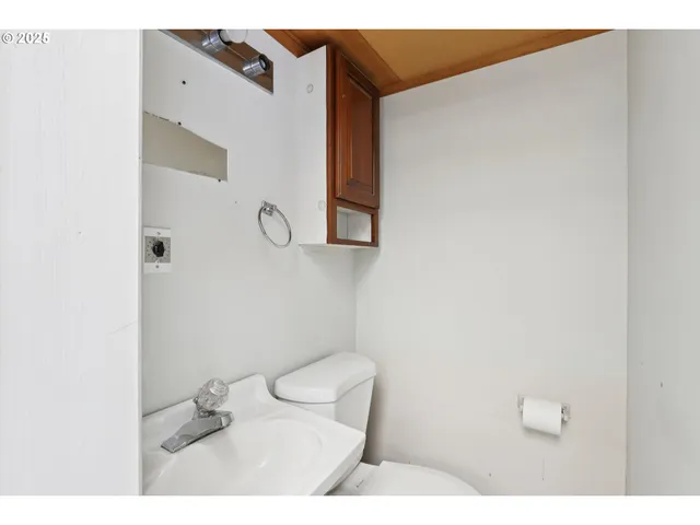a bathroom with a toilet and a mirror