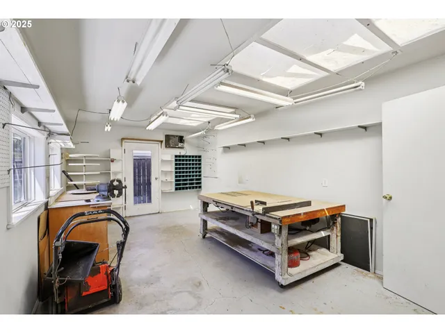 a room with furniture a flat screen tv and stainless steel appliances