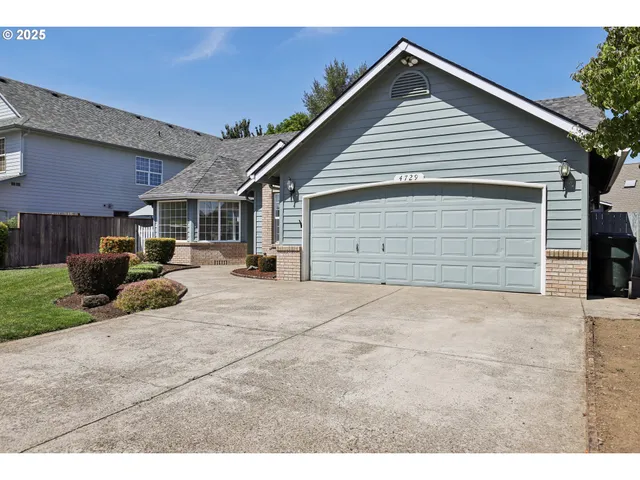 a view of garage yard and deck