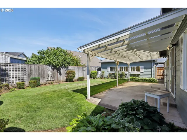 a view of a house with a yard and sitting area