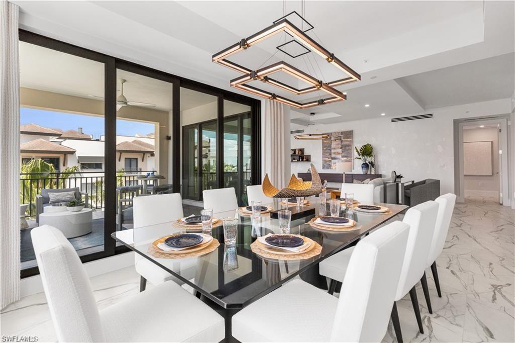 1130 3rd Avenue South, Unit 410 Avon Park, FL 33825 - Photo 14 of 21 Dining area with ceiling fan with notable chandelier