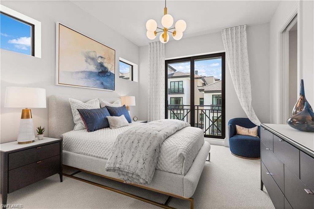 1130 3rd Avenue South, Unit 410 Avon Park, FL 33825 - Photo 3 of 21 Bedroom featuring light carpet and an inviting chandelier
