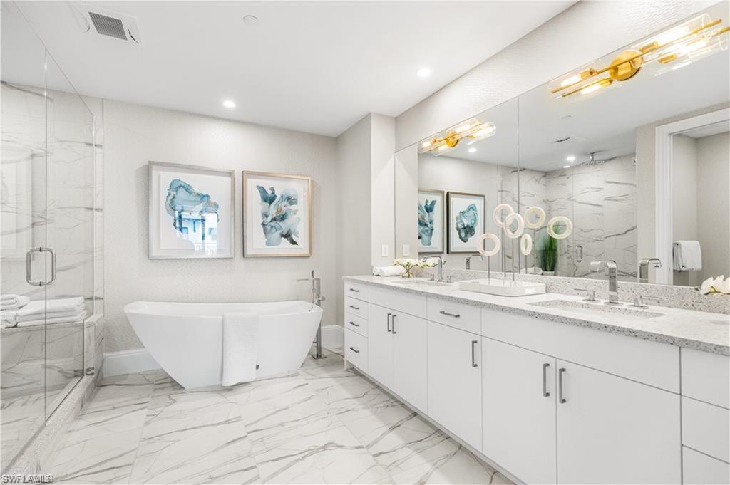 1130 3rd Avenue South, Unit 410 Avon Park, FL 33825 - Photo 6 of 21 Bathroom featuring vanity and separate shower and tub