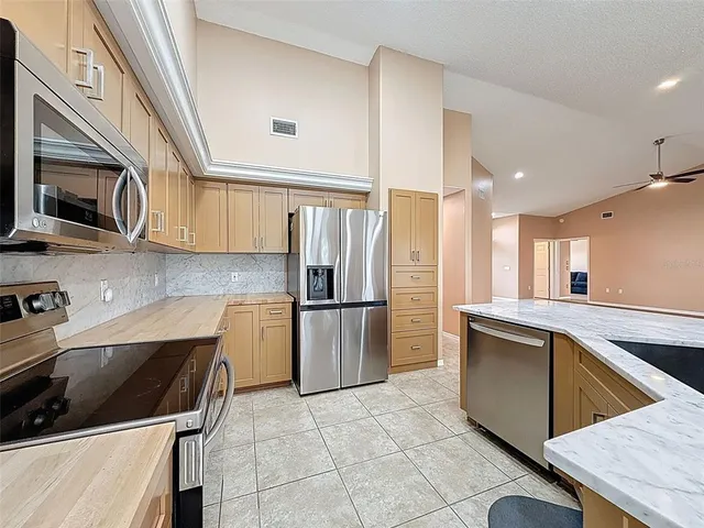 a bathroom with a granite countertop sink a toilet a mirror and shower