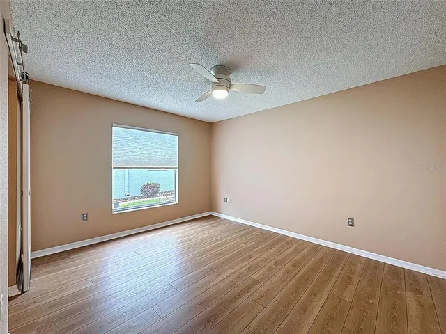 a view of a house with pool and a yard