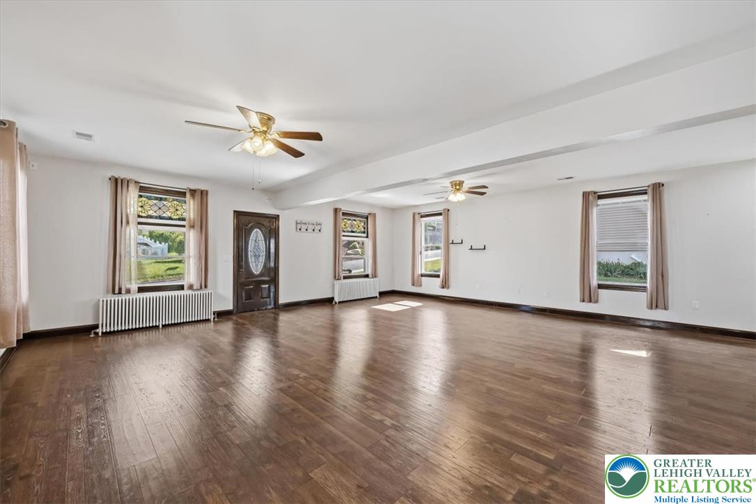 3453 Main Street Slatington, PA 18080 - Photo 4 of 30 Hardwood floors and generous windows define this welcoming, spacious living area, ideal for gathering.