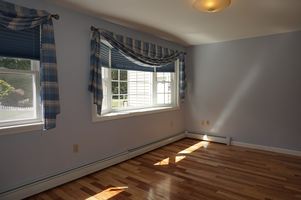 573 Reservoir Road Lunenburg, MA 01462 - Photo 13 of 26 a view of an empty room with wooden floor and a window