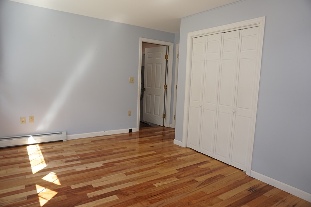 573 Reservoir Road Lunenburg, MA 01462 - Photo 14 of 26 a view of an empty room and wooden floor