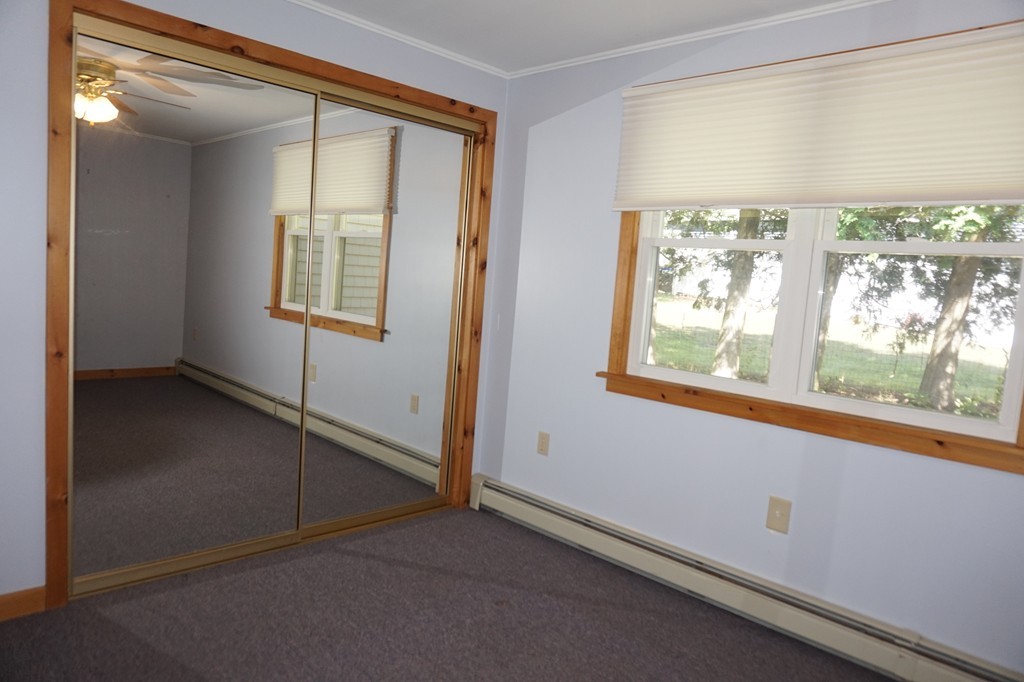 573 Reservoir Road Lunenburg, MA 01462 - Photo 17 of 26 an empty room with windows