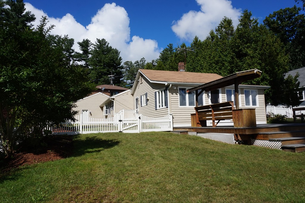 573 Reservoir Road Lunenburg, MA 01462 - Photo 23 of 26 a front view of a house with a yard table and chairs