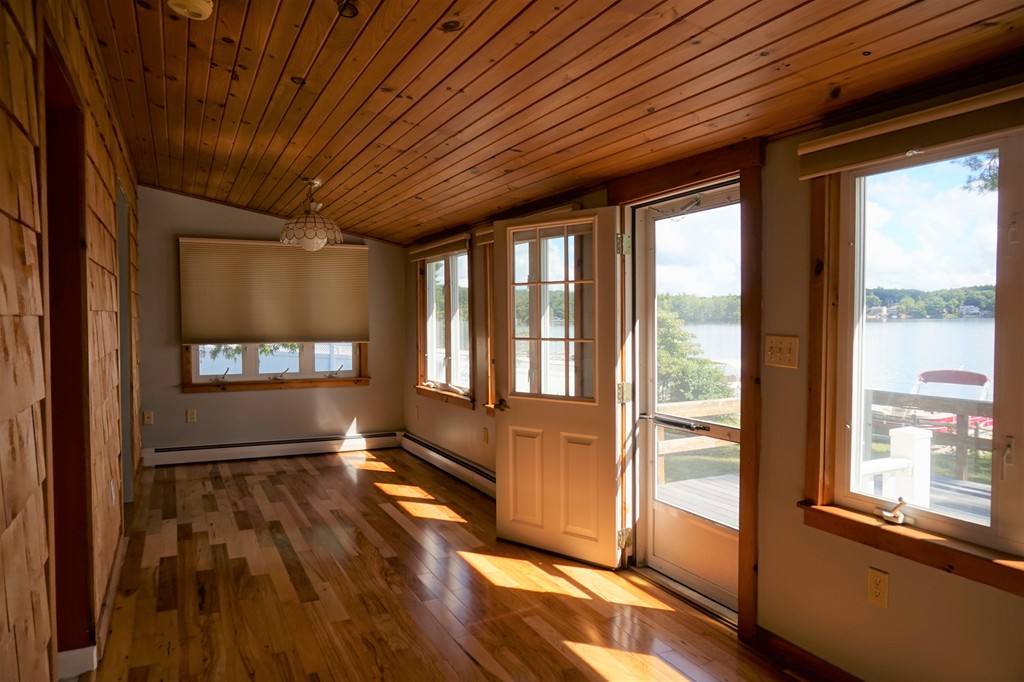 573 Reservoir Road Lunenburg, MA 01462 - Photo 3 of 26 a view of an empty room with wooden floor and a window