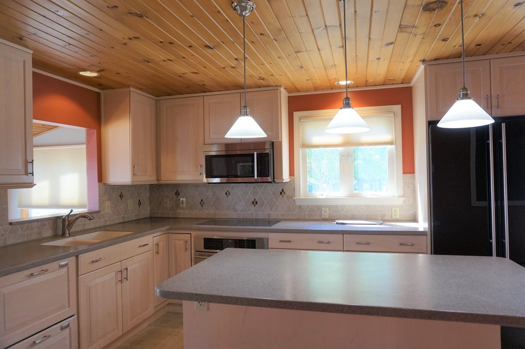 573 Reservoir Road Lunenburg, MA 01462 - Photo 5 of 26 a kitchen with stainless steel appliances granite countertop a sink a stove and a refrigerator