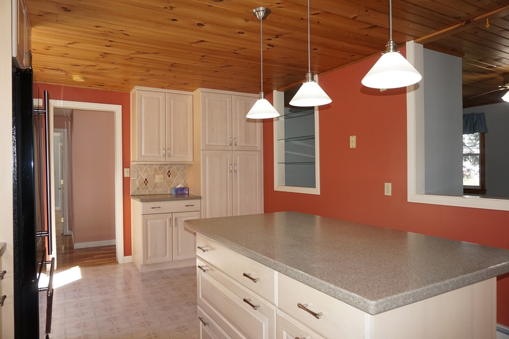 573 Reservoir Road Lunenburg, MA 01462 - Photo 8 of 26 a kitchen with a stove a refrigerator and chandelier