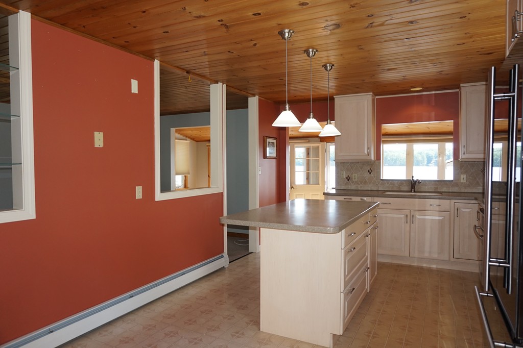573 Reservoir Road Lunenburg, MA 01462 - Photo 10 of 26 a kitchen with stainless steel appliances granite countertop a sink and a refrigerator