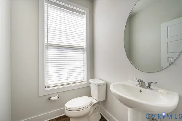 a bathroom with a sink toilet and a mirror