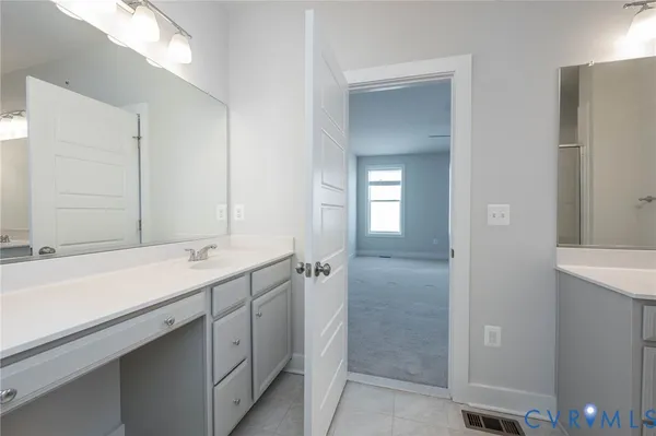 a bathroom with a sink and mirror