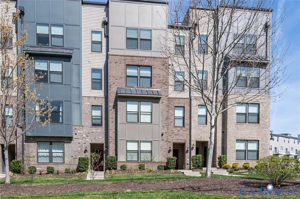a view of a brick building next to a yard
