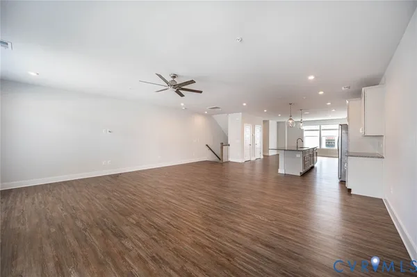 a view of empty room with wooden floor and windows