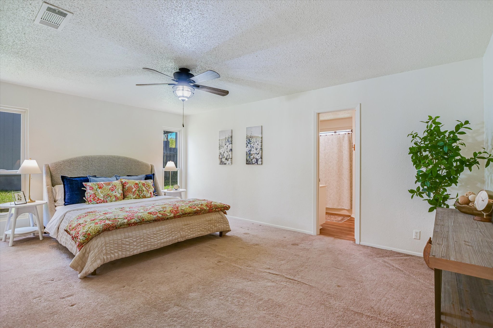 606 Splitrock Round Rock, TX 78681 - Photo 7 of 18 a bedroom with a bed chandelier and a window