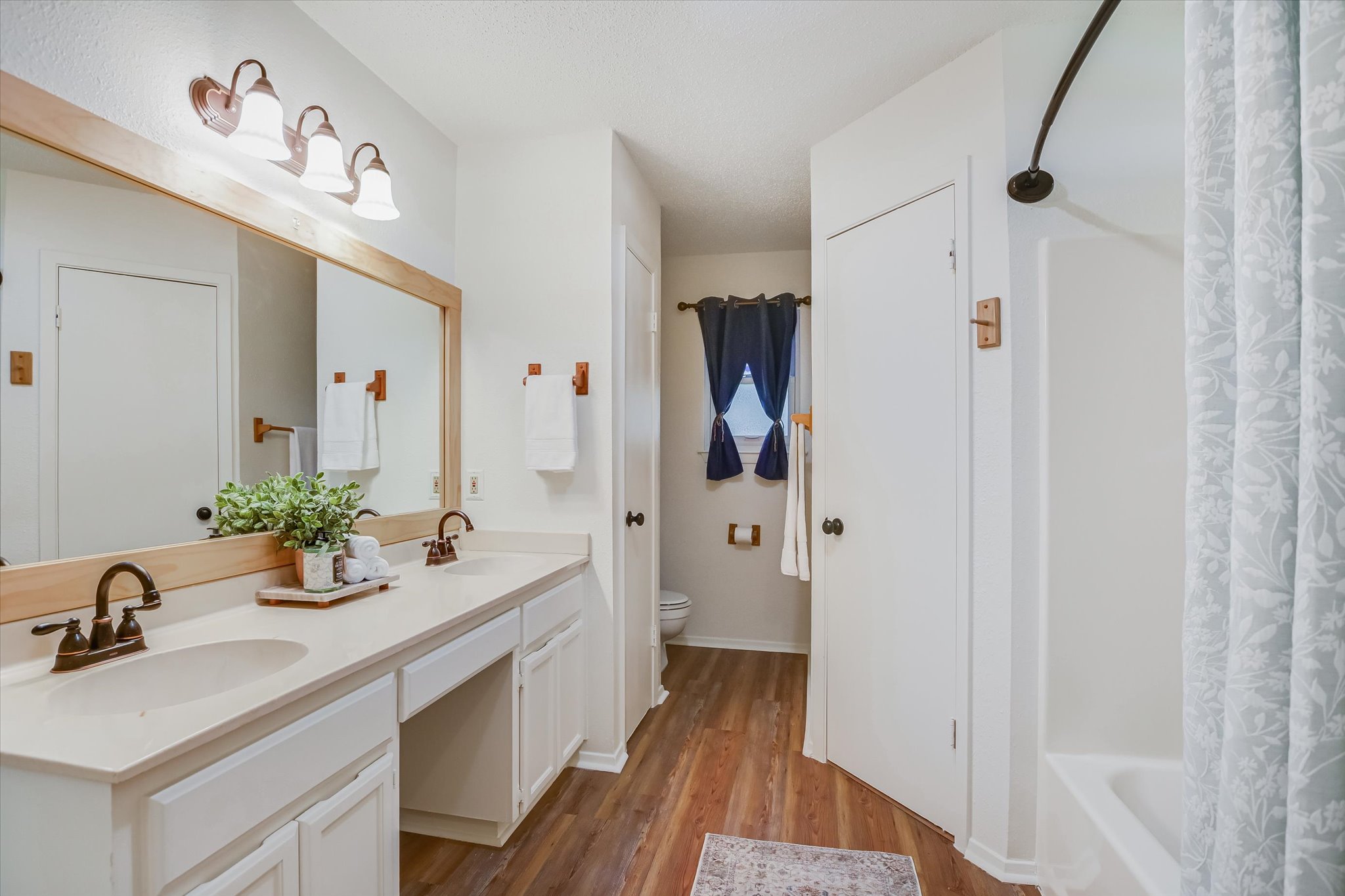 606 Splitrock Round Rock, TX 78681 - Photo 8 of 18 a bathroom with a sink a mirror a vanity and shower
