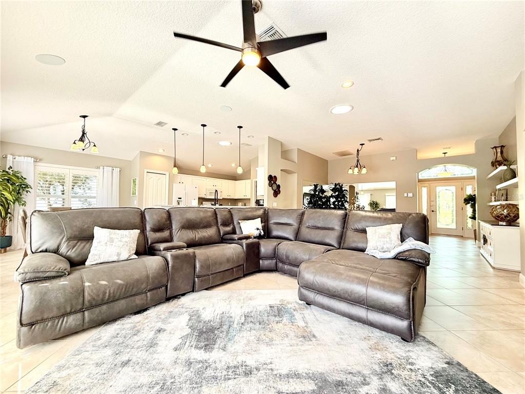 3088 Berwyn Way The Villages, FL 32162 - Photo 12 of 60 a living room with furniture kitchen view and a chandelier