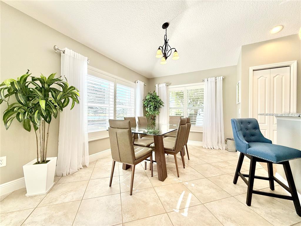 3088 Berwyn Way The Villages, FL 32162 - Photo 14 of 60 a view of a dining room with furniture and a potted plant