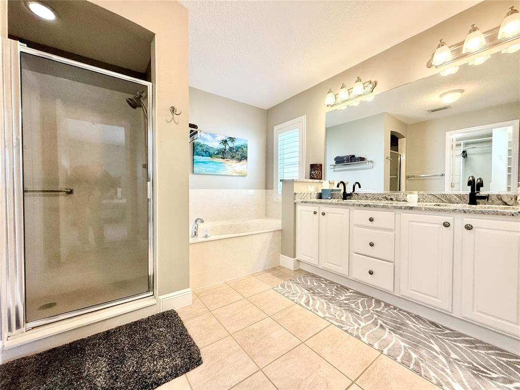 3088 Berwyn Way The Villages, FL 32162 - Photo 28 of 60 a bathroom with a shower sink and mirror