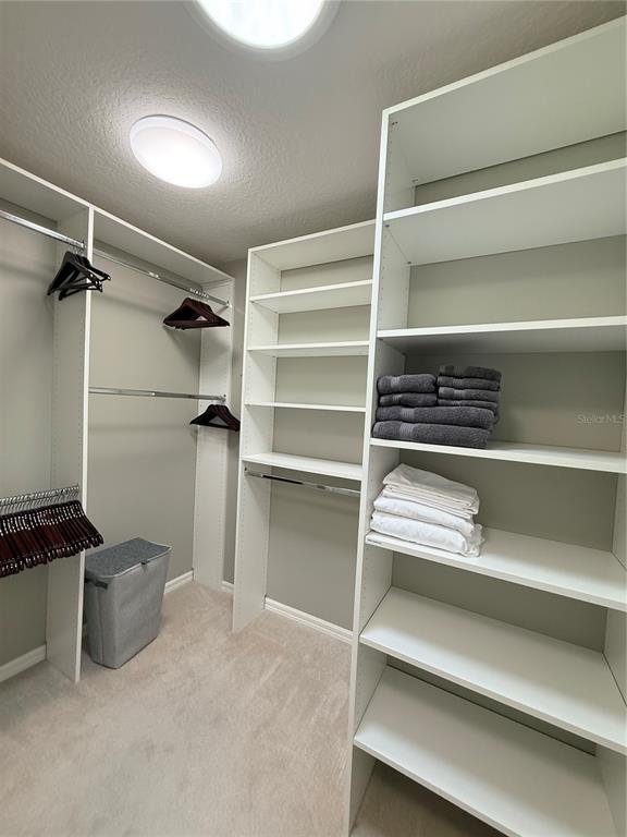 3088 Berwyn Way The Villages, FL 32162 - Photo 34 of 60 a view of walk in closet with empty racks