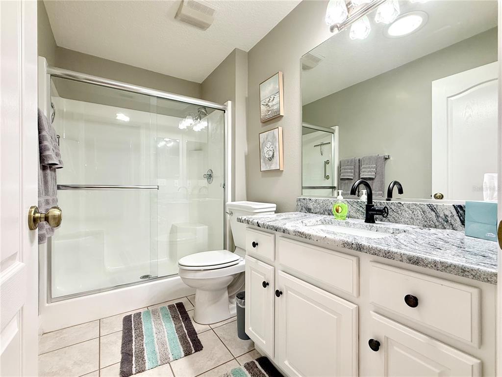 3088 Berwyn Way The Villages, FL 32162 - Photo 5 of 60 a bathroom with a granite countertop sink toilet and shower