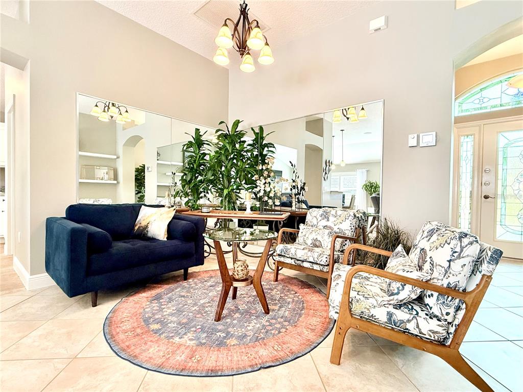 3088 Berwyn Way The Villages, FL 32162 - Photo 8 of 60 a living room with fireplace furniture and a large window