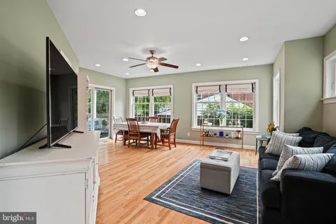 a living room with furniture and large windows
