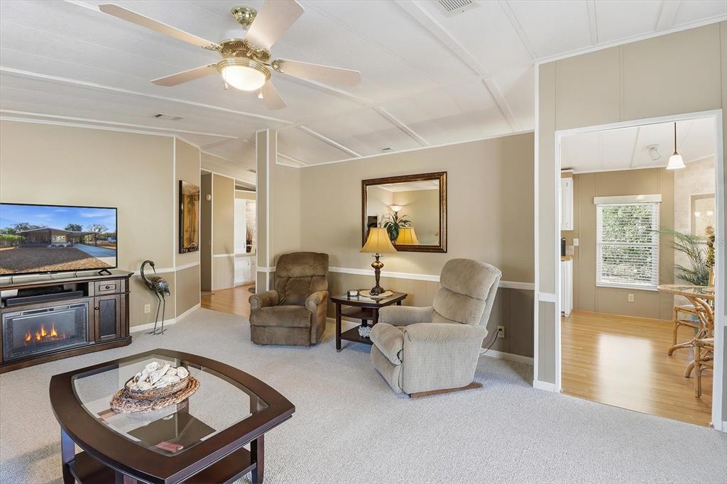 2285 North Loma Point Hernando, FL 34442 - Photo 11 of 36 a living room with furniture a fireplace and a chandelier