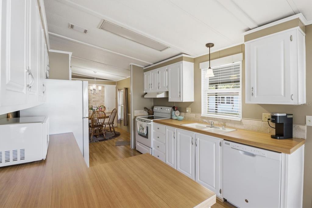 2285 North Loma Point Hernando, FL 34442 - Photo 15 of 36 a kitchen with a sink appliances cabinets and a large window