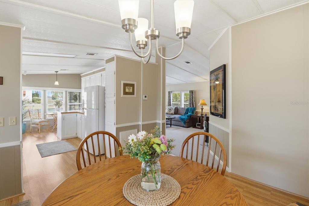 2285 North Loma Point Hernando, FL 34442 - Photo 18 of 36 a view of a dining room with furniture a chandelier and wooden floor