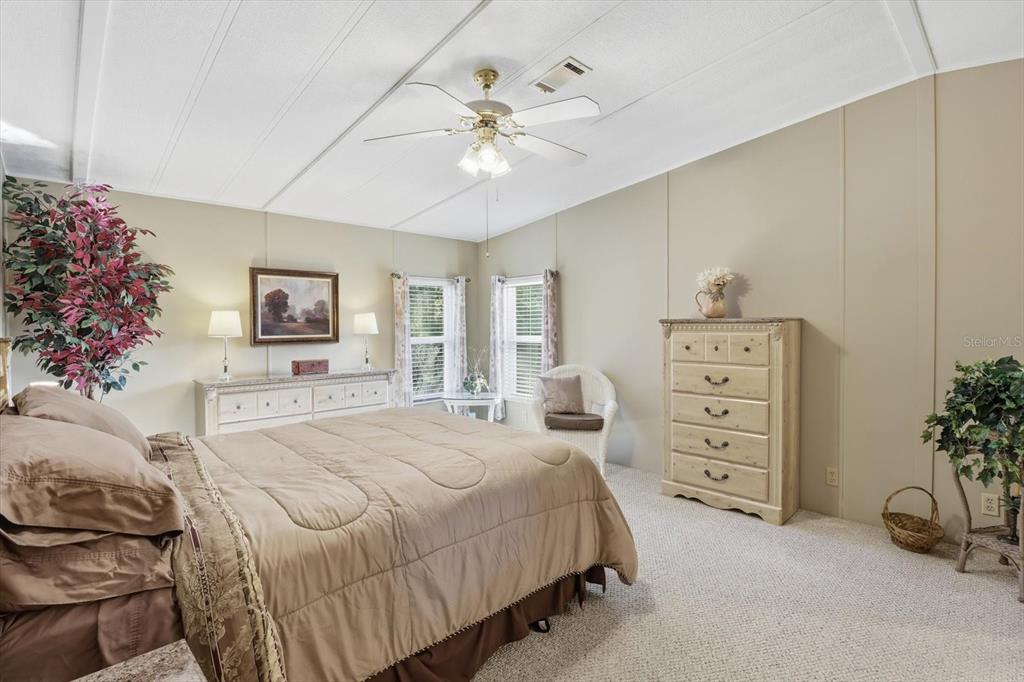 2285 North Loma Point Hernando, FL 34442 - Photo 23 of 36 a spacious bedroom with a bed and a couch