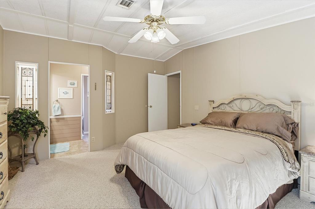 2285 North Loma Point Hernando, FL 34442 - Photo 24 of 36 a bedroom with a bed and a chandelier
