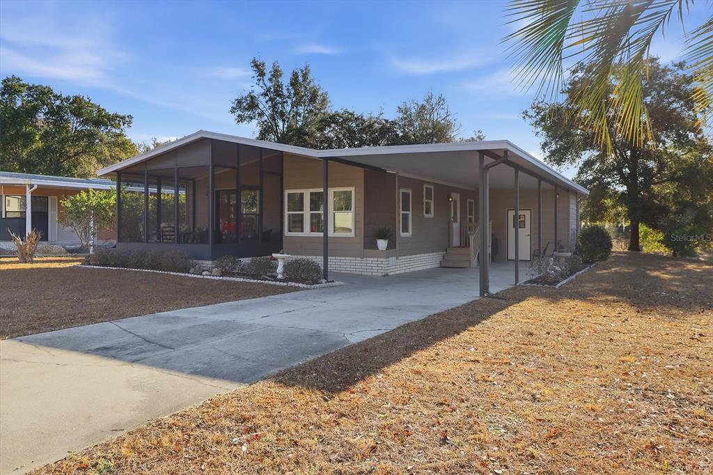 2285 North Loma Point Hernando, FL 34442 - Photo 3 of 36 a front view of a house with a yard and potted plants