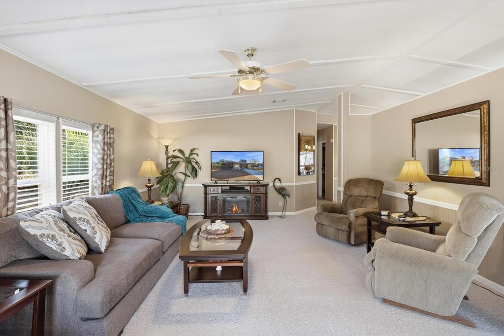 2285 North Loma Point Hernando, FL 34442 - Photo 10 of 36 a living room with furniture a chandelier fan and a window