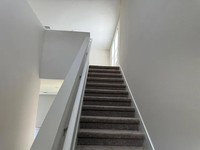 an empty room with an entryway and window