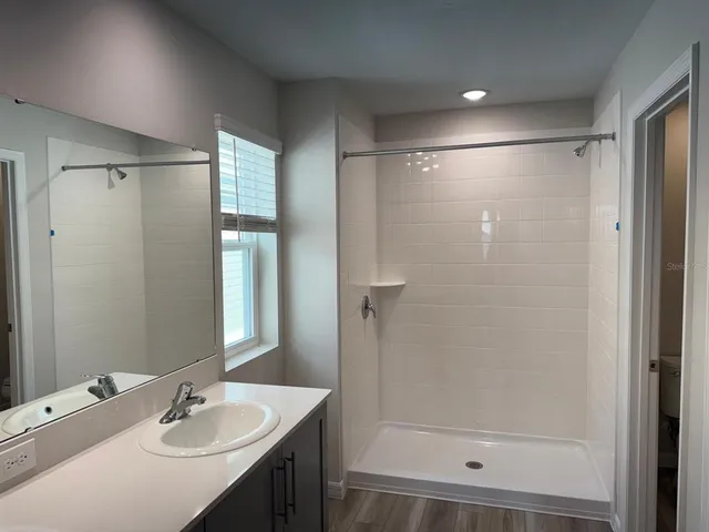 a view of a hallway with wooden shelves