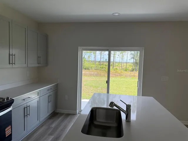 a view of a kitchen with a sink dishwasher and a microwave oven