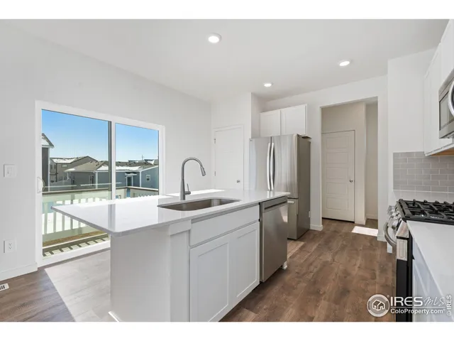 a kitchen with a sink and a refrigerator