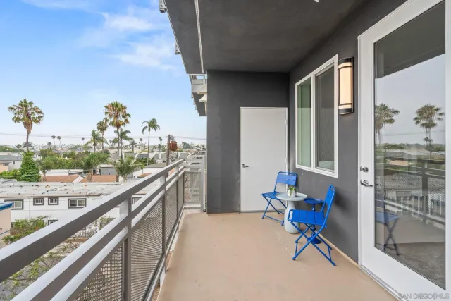 a balcony with furniture and potted plants