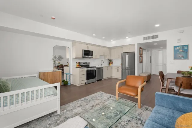 a kitchen with a refrigerator a stove top oven a sink dishwasher and wooden floor