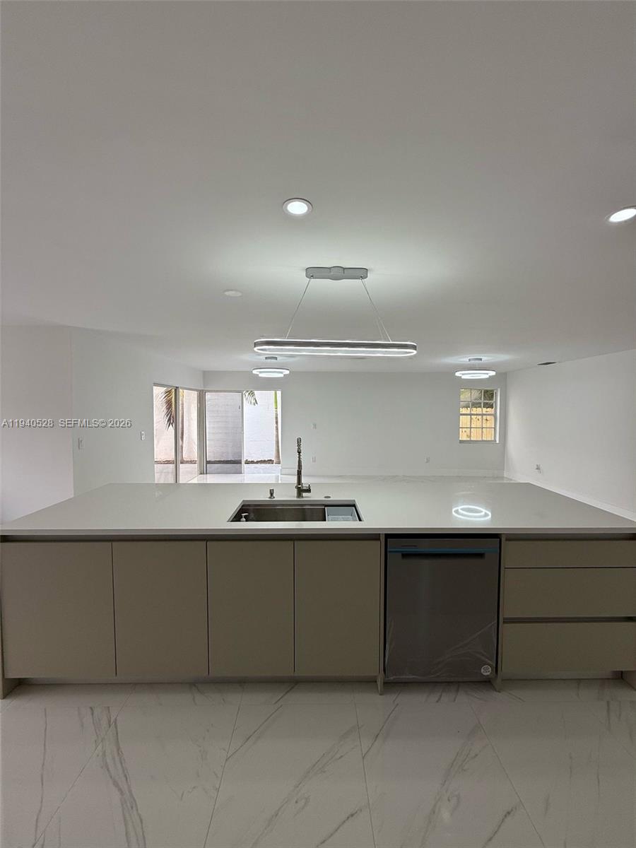 13911 Southwest 100th Lane Miami, FL 33186 - Photo 14 of 55 a kitchen with a sink and cabinets