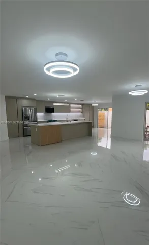 a view of a kitchen with a sink and dishwasher cabinets