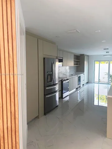 a view of a kitchen with a sink and cabinet