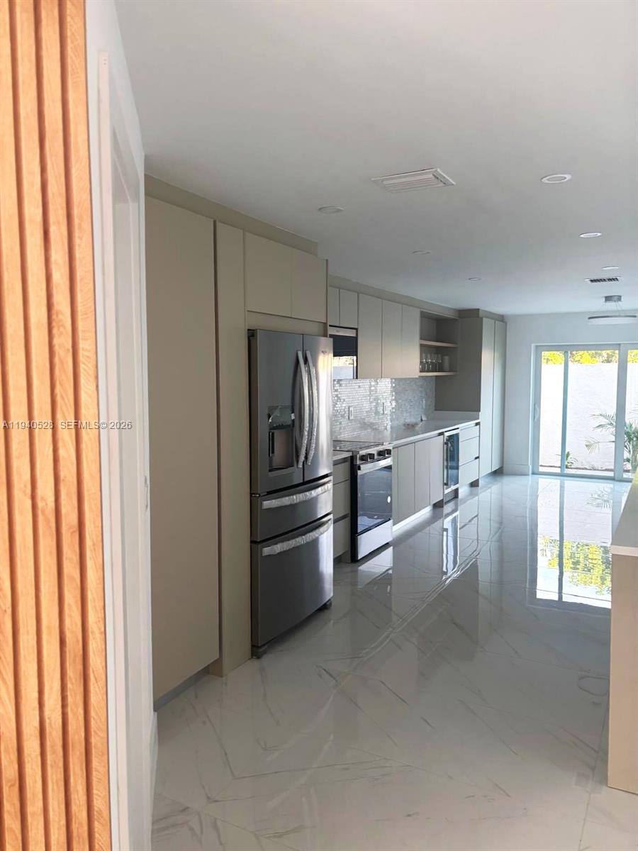 13911 Southwest 100th Lane Miami, FL 33186 - Photo 21 of 55 a kitchen with stainless steel appliances a refrigerator and a stove
