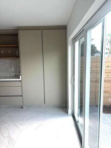 a view of water heater room with wooden floor