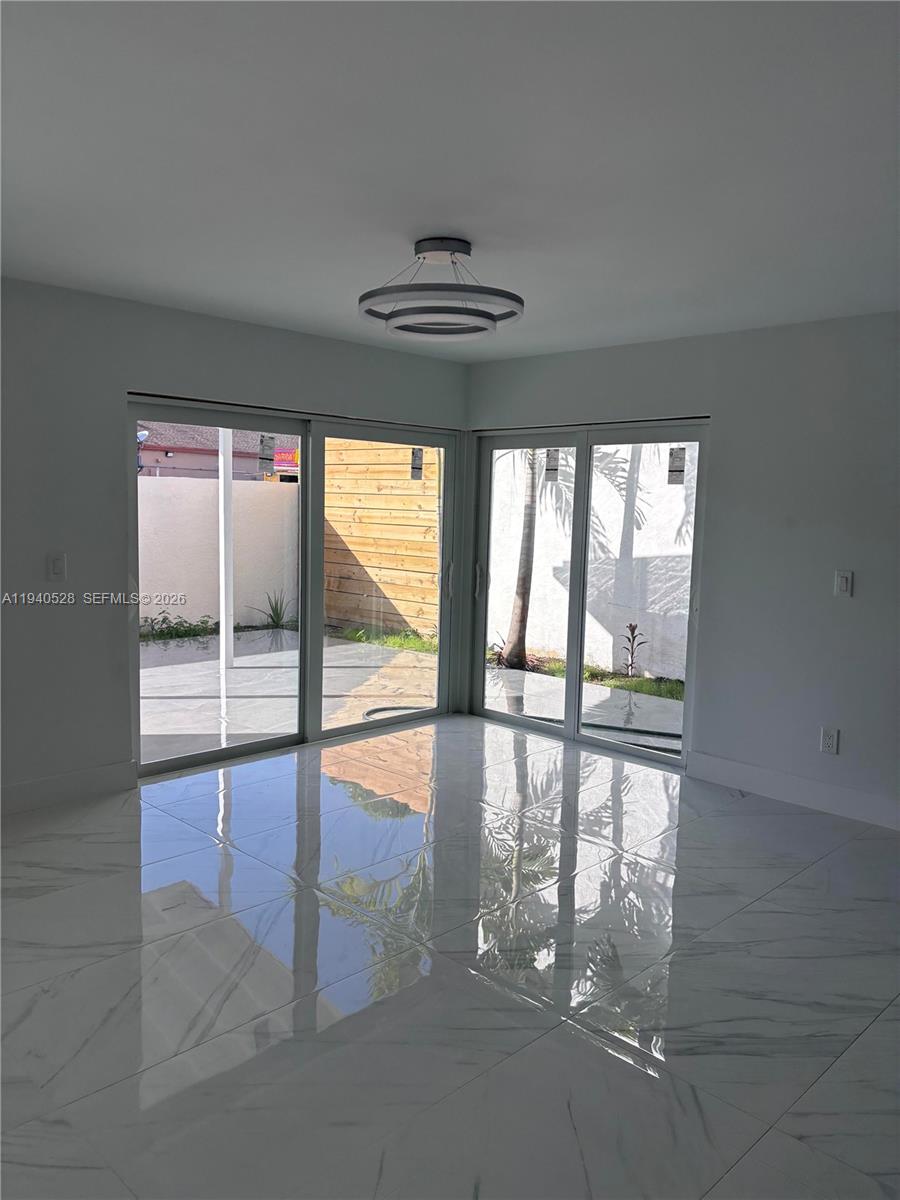 13911 Southwest 100th Lane Miami, FL 33186 - Photo 25 of 55 wooden floor in an empty room with a window